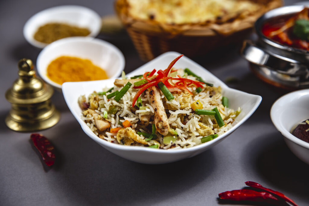 Basmati rice with grilled chicken and cucumber carrot bell pepper with spring onion salad